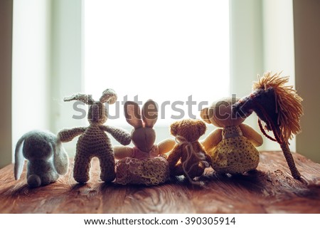 children's toys on wooden floor in front of the window