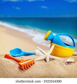children's toys for playing on the sand. Children's shovel, bucket and molds for the sandbox on the background of the sea