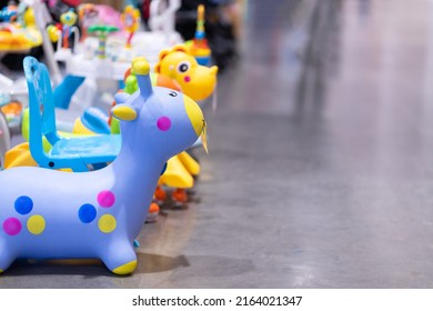 Children's Toys, Rubber Dolls Bounce Off The Bright Floor.