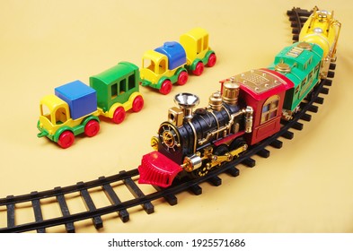 Childrens toys train and trucks on a yellow background.Transportation.