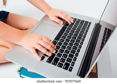 children's  are typing on a laptop - Powered by Shutterstock