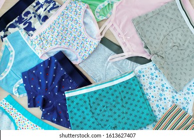 A lot of children's underwear. Underwear for children in the form of shirts and pants. Clothing for girls and boys. Background from underwear of different types. Cotton underwear.