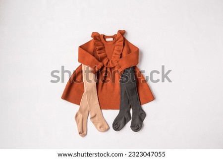 Children's wardrobe. View for a girl. Brown dress and leggings. Children's fashion. Layout, white background, top view. High quality photo Stock photo © 