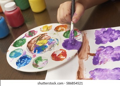 Children's watercolor painting moment. It is important for parents to encourage their kids interests and hobbies so that they are motivated and are keen on learning new things. - Powered by Shutterstock