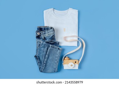 Childrens  White T-shirt With Jeans. Baby Clothes  For Spring, Autumn Or Summer On Blue Background. Fashion Kids Outfit. Flat Lay, Top View