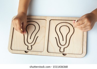 Children's Wooden  
Montessori Toy. Board For Interhemispheric Development Of The Brain. Children's Hands Close-up. Montessori Games For Child Development. Wooden Labyrinth For Speech Therapist. 