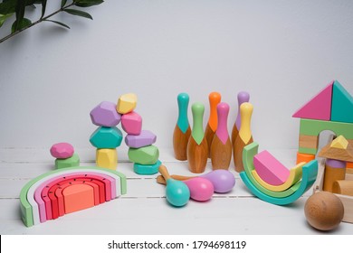 Children's Wooden Toys In Bright Colors. Toys Made From Natural Wood. Cubes, Rainbow, Rattles, Skittles, Pyramid. Safe Toys For Kids.