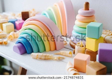 Children's wooden toys. Rainbow made of natural wood. Colorful Cubes and pyramid. Montessori toys. Eco-friendly, plastic free toys for kids. Zero waste concept. 