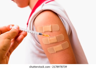 Child's Arm With Syringe And Band Aid.