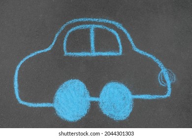 Child's Chalk Drawing Of Car On Asphalt, Top View