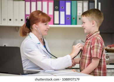 The Child's Doctor Examines The Baby Boy. They Are In The Office Smiling And Looking Happy