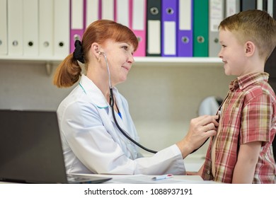 The Child's Doctor Examines The Baby Boy. They Are In The Office Smiling And Looking Happy