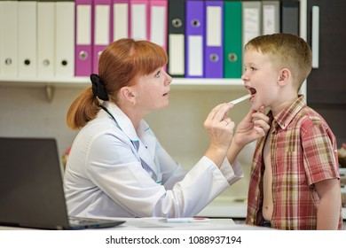 The Child's Doctor Examines The Baby Boy. They Are In The Office Smiling And Looking Happy