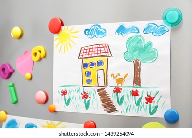 Child's Drawing And Magnets On Refrigerator Door As Background