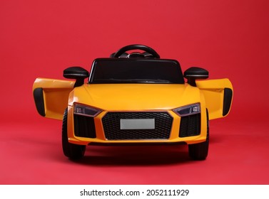 Child's Electric Toy Car On Red Background