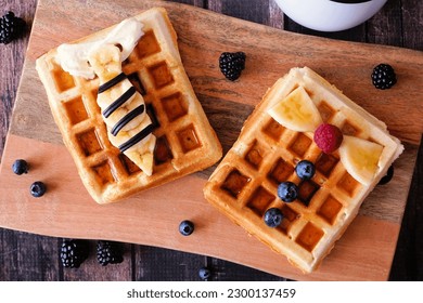 Child's Fathers Day shirt waffles with necktie and bowtie with buttons. Fathers Day breakfast concept. Top down view table scene on a dark wood background. - Powered by Shutterstock