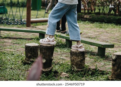 child's feet are walking on the playground footbridge, path of balance - Powered by Shutterstock