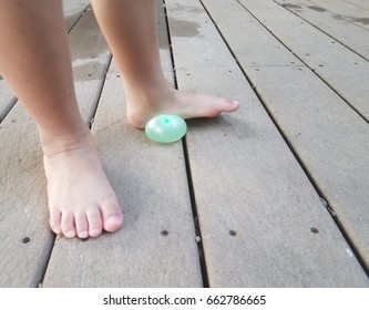 Child's Foot On Water Balloon