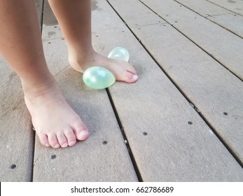 Child's Foot On Water Balloon