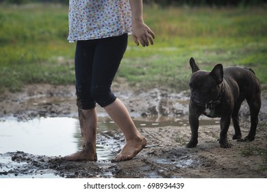 The Child's Foots In The Mud. Dog