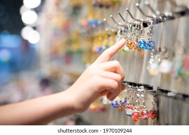Child's hand choosing glass miscellaneous goods - Shutterstock ID 1970109244