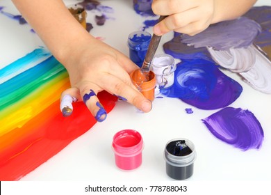 Child's Hand Draw Painting Colors On A White Background
