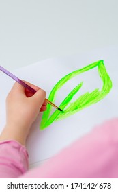 Child's Hand Drawing Green Leaf By Watercolors On White Sheet Of Paper. Earth Day Concept.