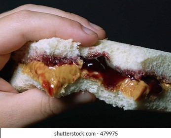 Child's Hand Holding Peanut Butter & Jelly Sandwich