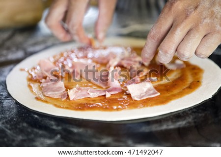 Child's hand make topping of Pizza  Stock photo © 