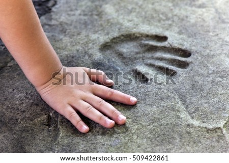 Childs hand and memorable handprint in  concrete