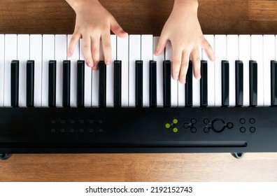 A Child's Hand Playing An Electronic Keyboard. Electronic Musical Instruments, Digital And Music Schools Concept Image.