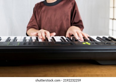 A Child's Hand Playing An Electronic Keyboard. Electronic Musical Instruments, Digital And Music Schools Concept Image.