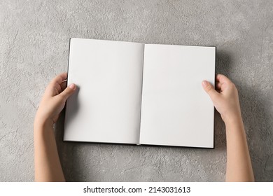 Child's hands with blank book on light background, closeup - Powered by Shutterstock