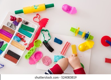 Child's Hands With Colorful Clay. Toddler Playing And Creating Toys From Play Dough. Boy Molding Modeling Clay.