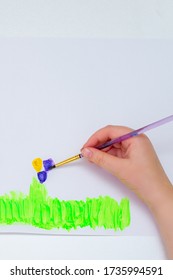 Child's Hands Drawing Flowers On White Sheet Of Paper. Top View. Children's And Earth Day Concept.