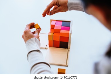 Child's Hands Learning To Fit Pieces In A 3d Wooden Puzzle.