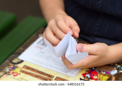 Child's Hands Making Paper Plane