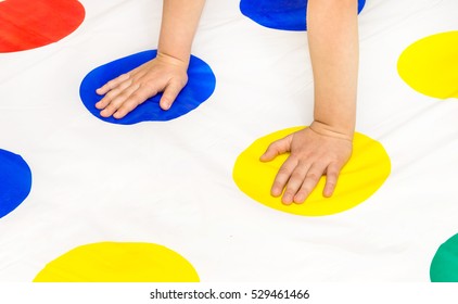 Child's hands on twister game