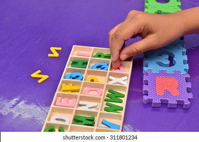 Child's hands playing with alphabet