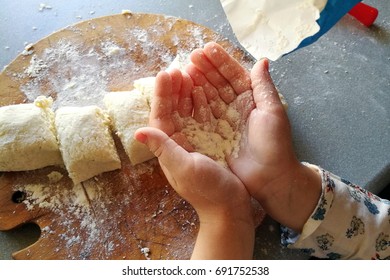 Child's hands playing with the flour