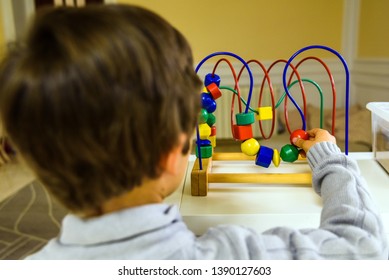 Child's Hands Using An Educational Toy For Their Cognitive Development.