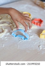 Child's Kid's Girl's Hand Holding Plastic Cake Mold, Car Shape, On Background Of Wooden Table Covered With Flour