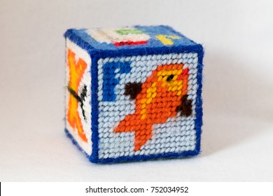 Child's Needlepoint Alphabet Block. Letter F With Fish Image. White Background.