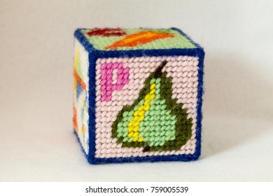 Child's Needlepoint Alphabet Block With Letter P And Image Of A Pear. White Background.