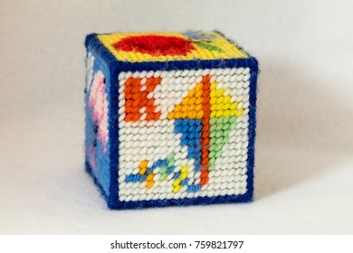 Child's Needlepoint Alphabet Block With Letter K And Image Of A Kite. White Background.