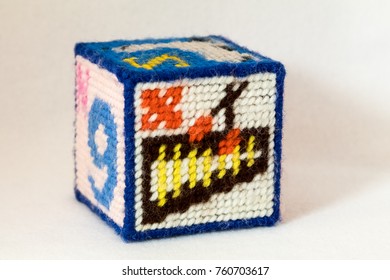 Child's Needlepoint Alphabet Block With Letter X And Image Of A Xylophone. White Background.