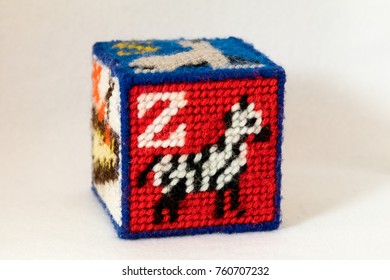 Child's Needlepoint Alphabet Block With Letter Z And Image Of A Zebra. White Background.