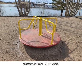 A Child's Playground With The View Of A Merry Go Round.