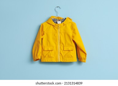 Child's Raincoat Hanging On Blue Wall