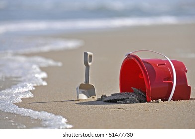 A Child's Sand Bucket At The Beach